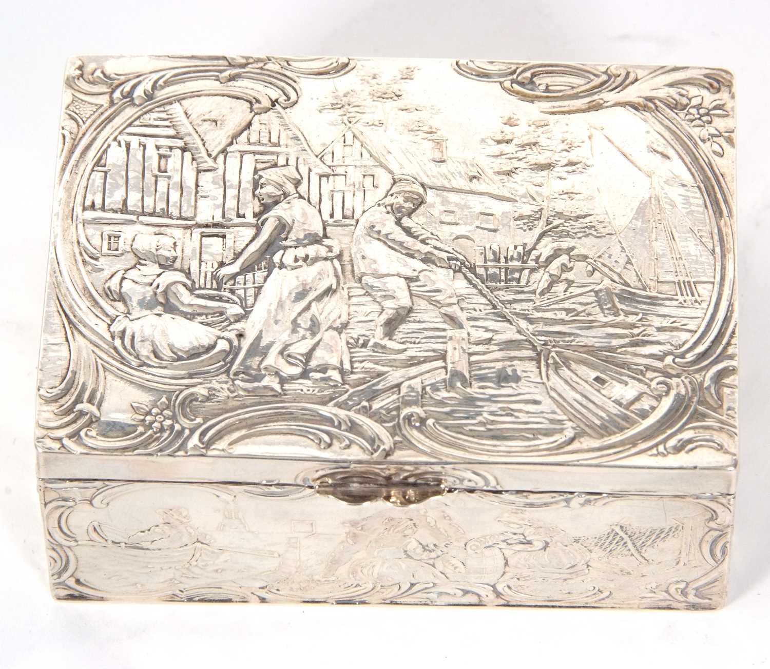 A Dutch white metal box of rectangular form, the lid and sides decorated with figures, boats, nets - Image 2 of 7