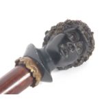 A vintage walking stick with painted resin Bacchanalian bust of a gentleman, the hardwood shaft