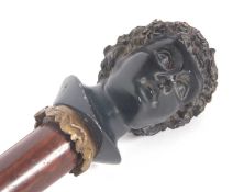 A vintage walking stick with painted resin Bacchanalian bust of a gentleman, the hardwood shaft
