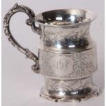 A Victorian silver small mug of cylindrical form, engraved and chased with birds, deer and foliate