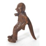 A vintage Black Forest nut cracker, circa 1930 of figural form showing a seated older man with a