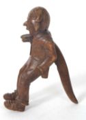 A vintage Black Forest nut cracker, circa 1930 of figural form showing a seated older man with a