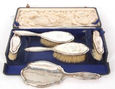 Cased George V silver backed dressing table set to include hand mirror, two hair brushes, two