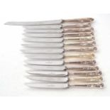 Six Kings pattern table knives and six matching dessert knives together with a hallmarked silver