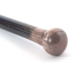 An early 20th Century black painted tapering cane, hallmarked silver handle for London 1920,