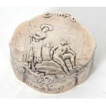 A white metal Dutch oval shaped box embossed to the lid with a pair of figures in a garden