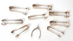 Mixed Lot: Eight pairs of hallmarked silver sugar tongs, together with a pair of wishbone
