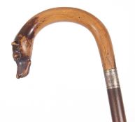 Vintage walking stick, the curved handle with a dogs head having inset glass eyes and a metal