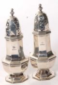 Pair of George V silver casters of octagonal form, panel bodies with pull off pierced lids and urn