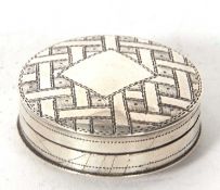 A George III silver patch box, chased and engraved with geometric design around a vacant