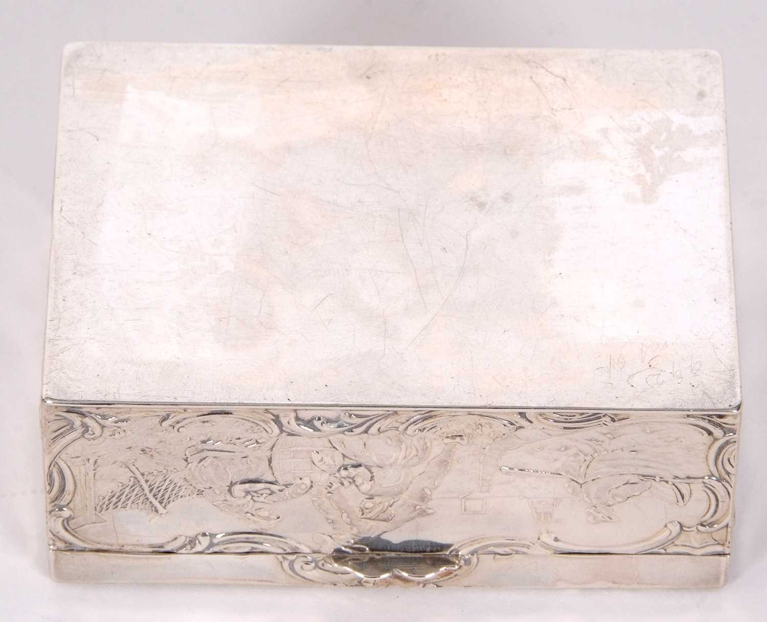 A Dutch white metal box of rectangular form, the lid and sides decorated with figures, boats, nets - Image 7 of 7