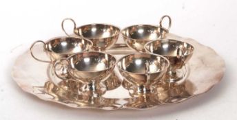 Swedish silver tray, makers mark G.A.B, 27cm diameter together with six Swedish cups, makers mark