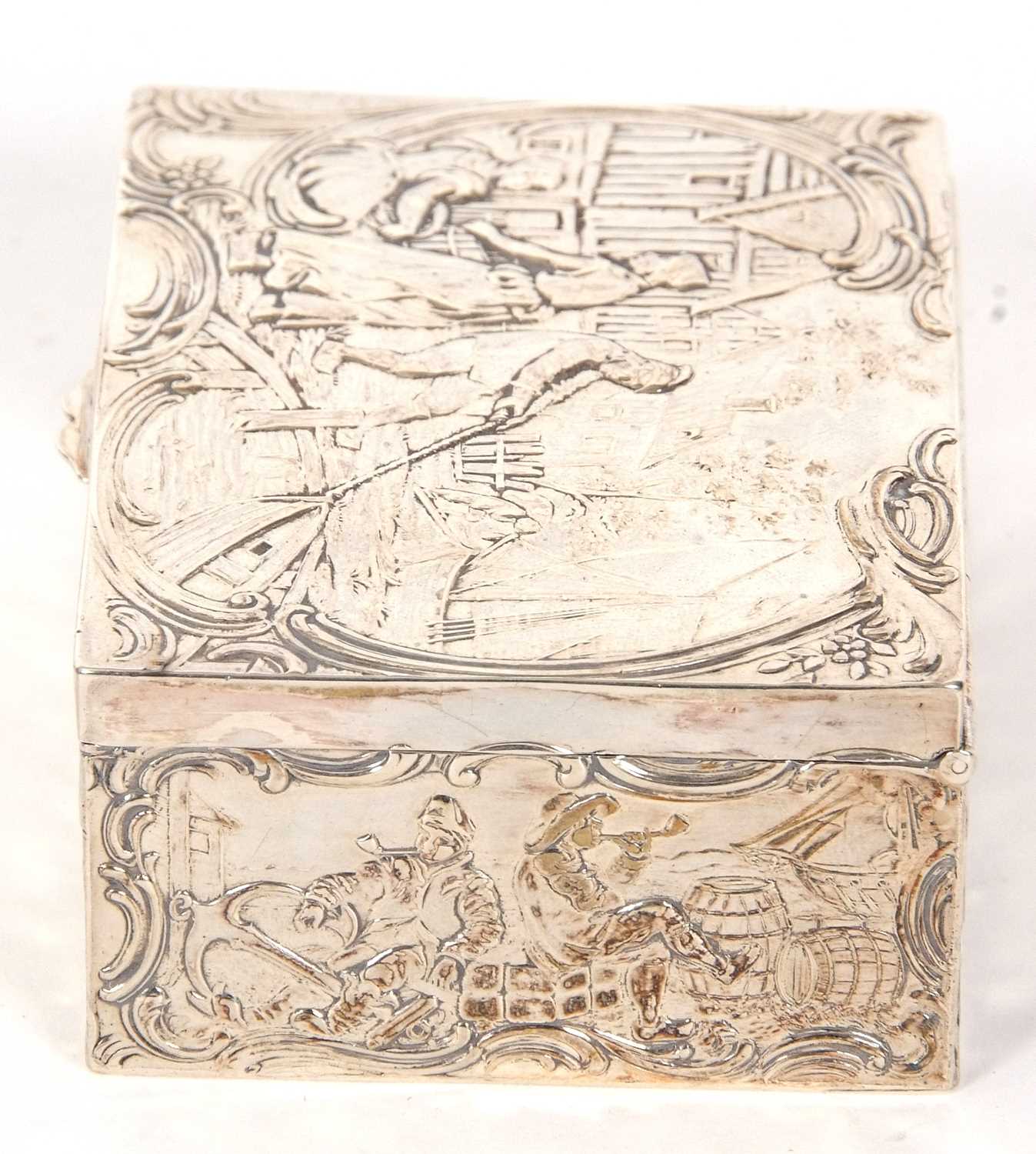 A Dutch white metal box of rectangular form, the lid and sides decorated with figures, boats, nets - Image 3 of 7