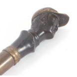 Vintage walking stick/cane with a weighted brass jockeys head on a later wooden shaft (a/f)