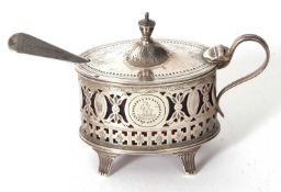 A Victorian silver mustard of oval form, hinged lid with urn finial, the body with a pierced