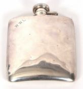 A vintage white metal spirit flask of slightly curved rectangular form, plain polished with engraved