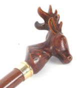 A carved stags head walking stick, gilt metal ferrule and cane shaft