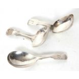 Group of three silver caddy spoons, a George III shell and thread example, having a square shaped