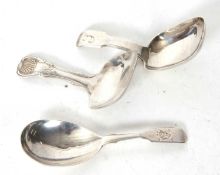 Group of three silver caddy spoons, a George III shell and thread example, having a square shaped