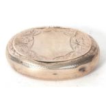 An Edwardian silver peddle snuff box of oval form chased and engraved all over and around a shield
