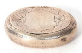 An Edwardian silver peddle snuff box of oval form chased and engraved all over and around a shield