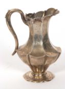 Victorian silver jug of octagonal panelled form, applied decorated rim, the body chased and engraved