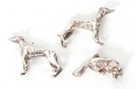 A group of two small hallmarked silver greyhounds and a fox, London 1976/77, makers mark S.M.C