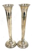 Pair of Elizabeth II silver tall spill vases having beaded decoration to rims and bases, engraved