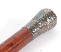 A vintage stained bamboo shaft walking stick with embossed white metal handle (a/f)
