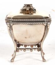 An Edwardian silver casket of sarcophagus form on integral stand having ring turned folding handles,
