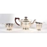 An Art Deco three piece silver tea service comprising teapot, cream jug and twin handled sugar bowl,