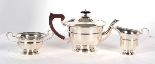 An Art Deco three piece silver tea service comprising teapot, cream jug and twin handled sugar bowl,