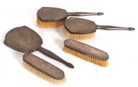 Five piece silver mounted dressing table wares to include hand mirror, two hair brushes and two
