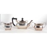 A matched three piece tea service of plain form with cantered corners and applied gadrooned rims,
