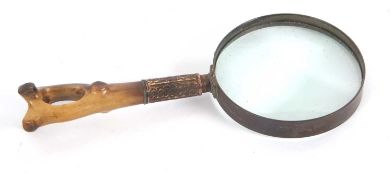 Vintage magnifying glass with carved horn handle and embossed metal ferrule, the glass diameter