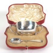Cased late Victorian twin handled Christening bowl and spoon, the plain bowl hallmarked for London