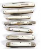 Group of seven mother of pearl handled folding fruit knives with steel blades