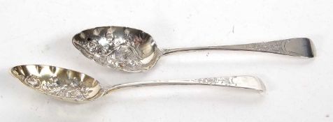 Pair of George III silver spoons having oval shaped bowls elaborately embossed with flowers and