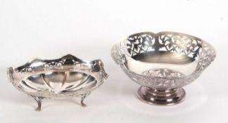 A hallmarked silver pedestal dish having a pierced scroll edge supported on a spreading foot,