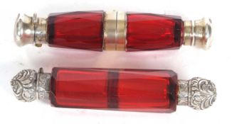 A Victorian ruby glass binocular double ended scent bottle, the faceted glass folds at the mid