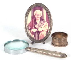 Mixed Lot: A sterling marked photograph frame with easel back, 10 x 7cm, a serviette ring, Chester