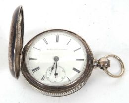 A white metal pocket watch stamped coin in the case, the pocket watch is by Elgin and it features