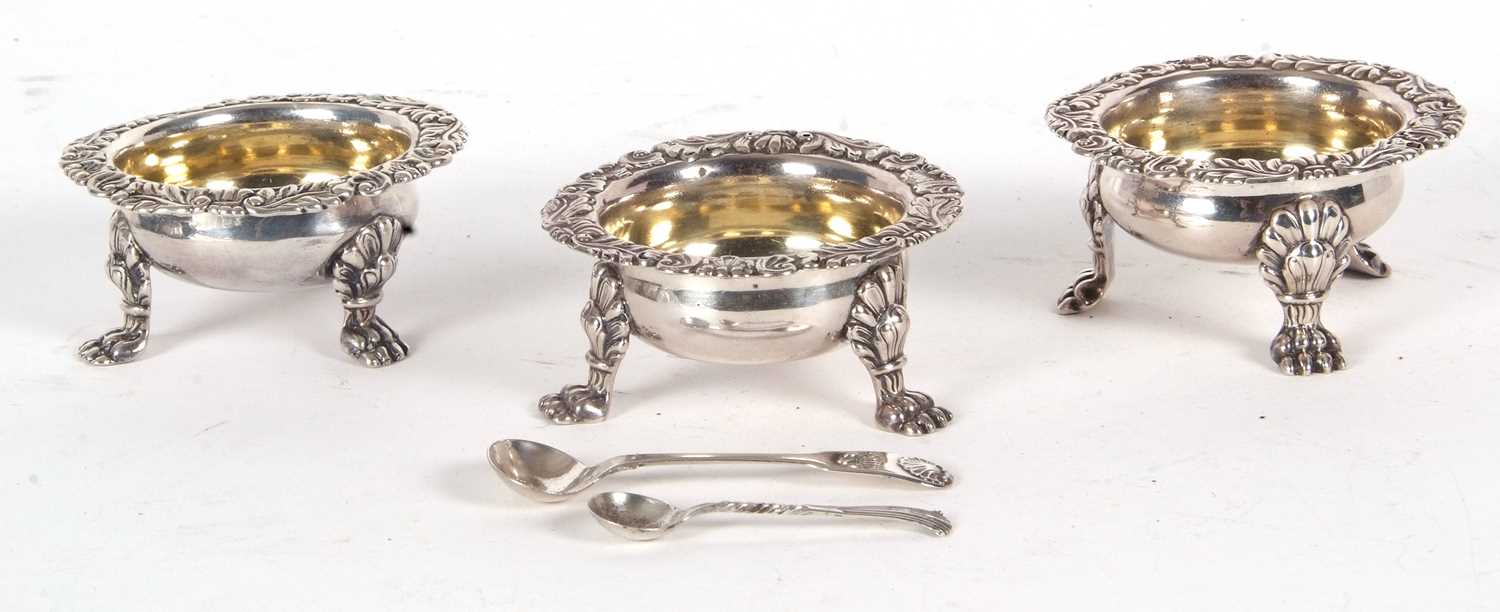 Three Georgian silver cauldron salt cellars having plain bodies with cast border of shells,