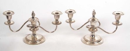 Pair of Barker & Ellis silver plated twin branch table candelabra with gadrooned rims and loaded