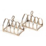 A pair of Art Deco silver toast racks of lancet form having four divisions with central carrying