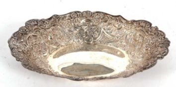 A late Victorian oval shaped dish, heavily embossed with flowers and scrolls etc, London 1894,