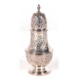 A hallmarked silver caster of baluster form, having a pull off pierced lid with urn finial, chased