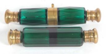 A Victorian green faceted glass binocular scent bottle together with a double ended green glass