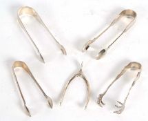 Group of four pairs of silver sugar tongs, and a pair of sugar nips, various dates/makers, 150gms