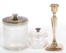 George V silver candlestick of tapering octagonal form, loaded base and hallmarked for Birmingham